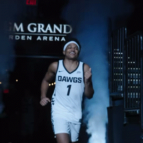 a basketball player in a dawgs jersey is running