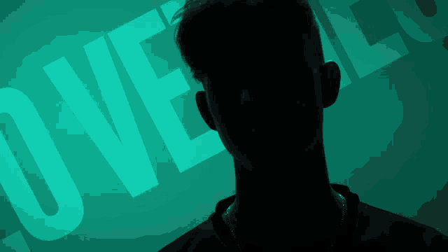 a man 's face is silhouetted against a green background with the word love on it