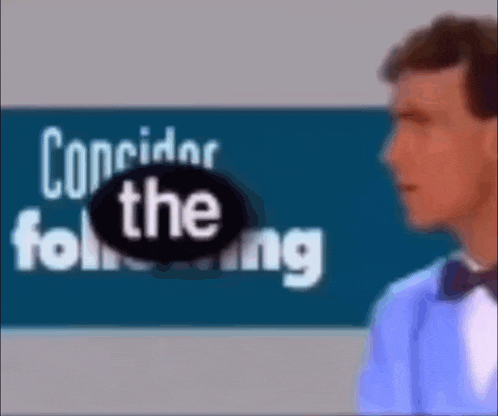 a man in a tuxedo is standing in front of a sign that says corridor the following
