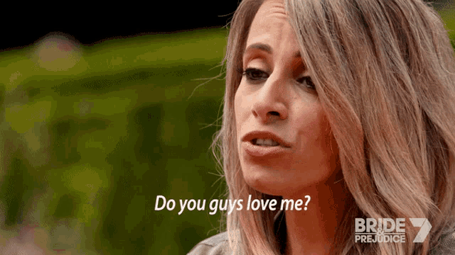 a woman says " do you guys love me " in front of a green background