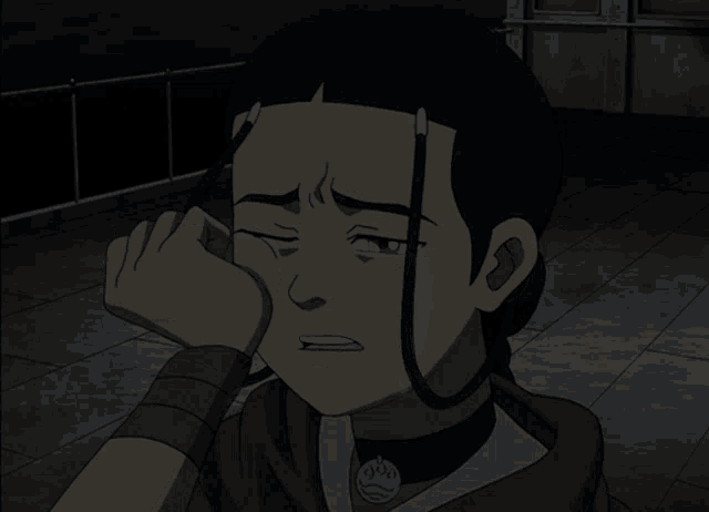 a cartoon character is crying with a necklace that says ' aang ' on it