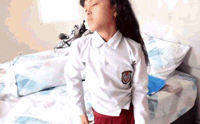 a girl in a school uniform has a patch on her shirt that says ' sd '