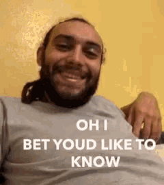 a man with dreadlocks and a beard is smiling and says oh i bet you 'd like to know