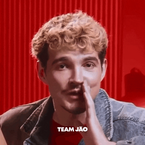 a close up of a man 's face with the word team jao written above him