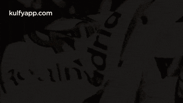 a person is holding a madrid flag in their hands .