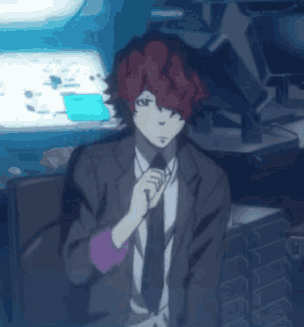 a man in a suit and tie is standing in front of a computer screen
