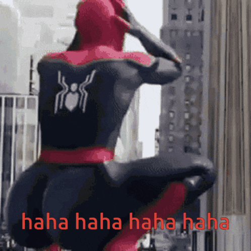 a man in a spiderman suit is standing in front of a building with the words " haha haha haha haha " below him