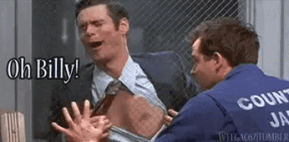a man in a suit and tie is being attacked by a prisoner in a blue jacket .