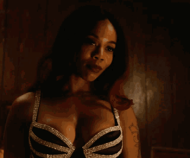 a woman with a tattoo on her arm has a bra on