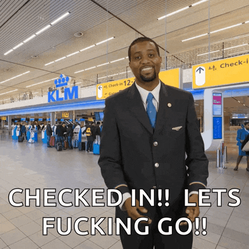 a man standing in front of a klm sign
