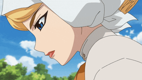 a close up of a woman 's face with a white head scarf around her head