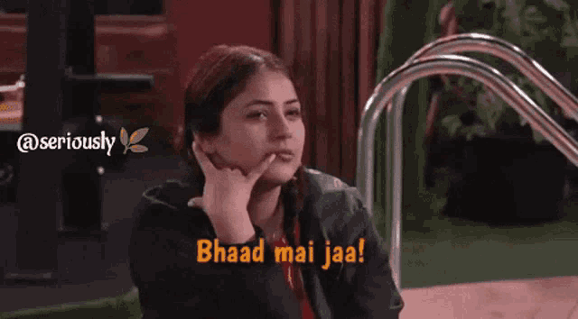 a woman talking on a cell phone with a caption that says bhad mai jaa !