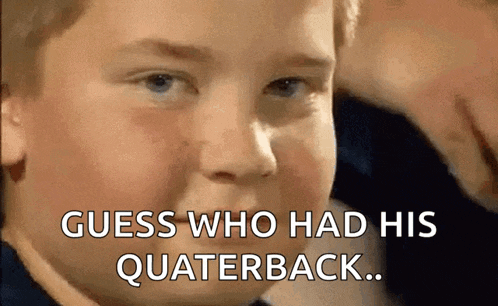 a young boy is making a funny face with the words guess who had his quaterback