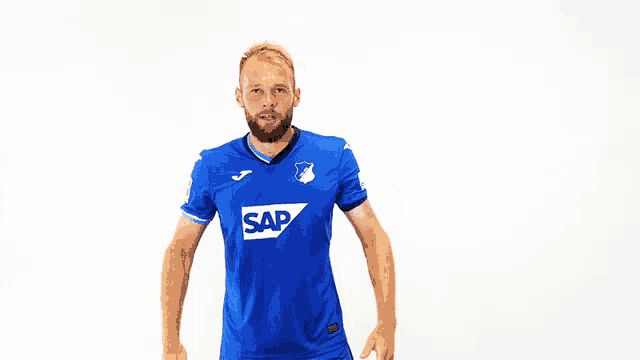 a man is wearing a blue shirt with the word sap on it