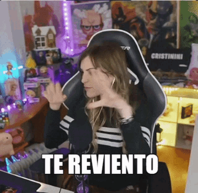 a woman in a black and white striped shirt is sitting in a chair and says te reviento