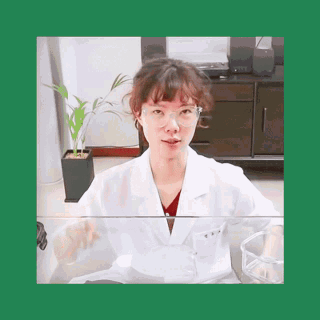 a woman wearing glasses and a lab coat has the letters tss on the front of her coat