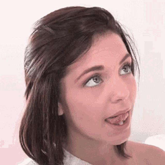 a close up of a woman with her tongue hanging out .