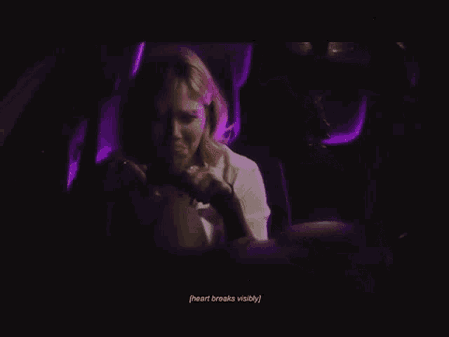 a woman is driving a car with purple lights behind her and the words sadness and anger overhelm