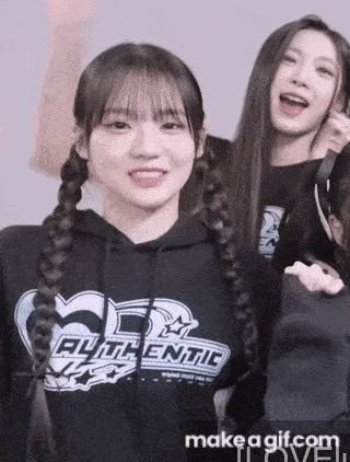 a girl with braids is wearing a black authentic hoodie .