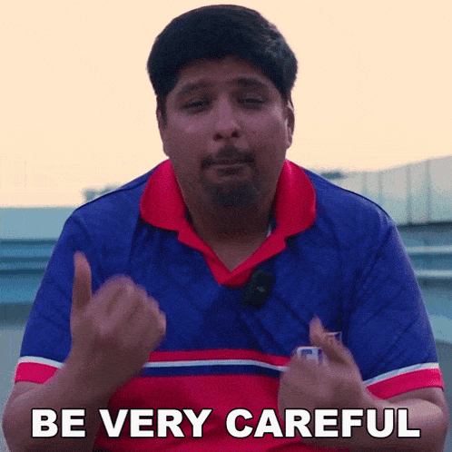 a man in a red white and blue shirt is saying be very careful