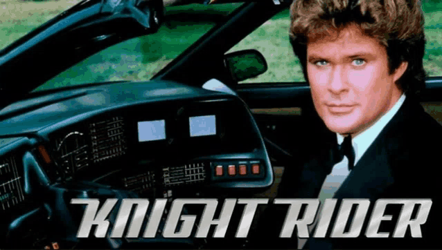 a man in a tuxedo sits in the driver 's seat of a car that says knight rider on the bottom