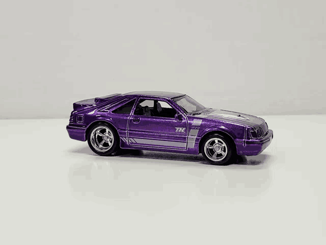 a purple toy car that says tnt on the side