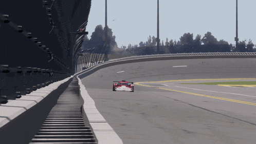 a red and white race car is going down a track