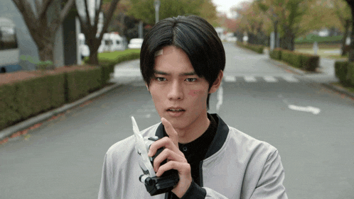 a man with a bandage on his forehead is holding a sword