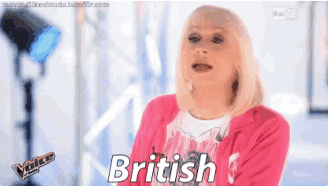 a woman in a pink jacket is saying british on a tv show