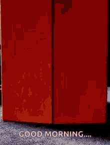 a red refrigerator with the words " good morning " on it