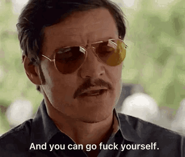 a man with a mustache and sunglasses is talking and you can go fuck yourself .
