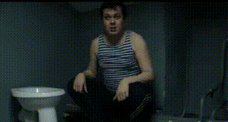a man in a tank top is holding a diving helmet