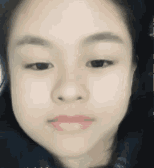 a close up of a girl 's face with her eyes closed and pink lips