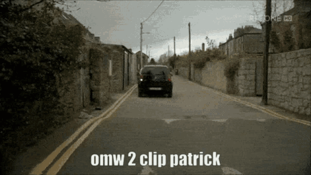 a black car is driving down a street with the words omw 2 clip patrick on the bottom