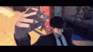 a man in a suit and tie is holding up his hand