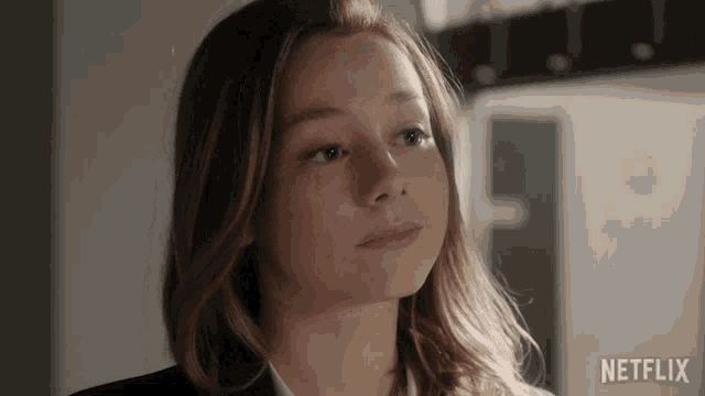 a close up of a woman 's face with the netflix logo in the corner