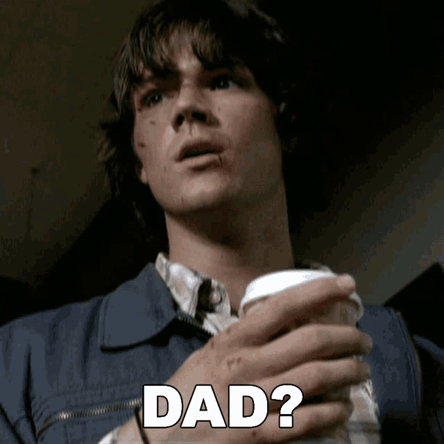 a man in a blue jacket is holding a cup and the word dad is above him