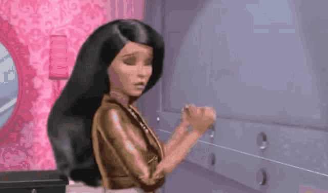 a barbie doll is standing in a room with a pink wall