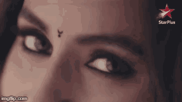 a close up of a woman 's eye with a star plus logo in the corner