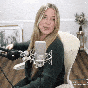 a woman is sitting in front of a microphone with the words vibe to her voice visible