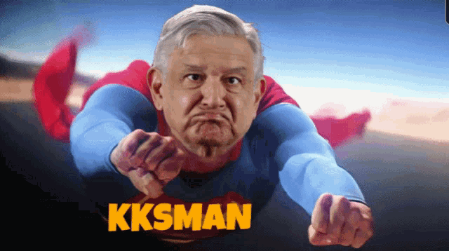 a man in a superman costume is pointing at the camera and the word kksman is above him
