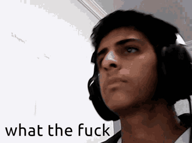 a man wearing headphones with the words what the fuck written below him