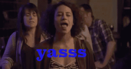 a woman is dancing in a bar and the word yasss is on the bottom right