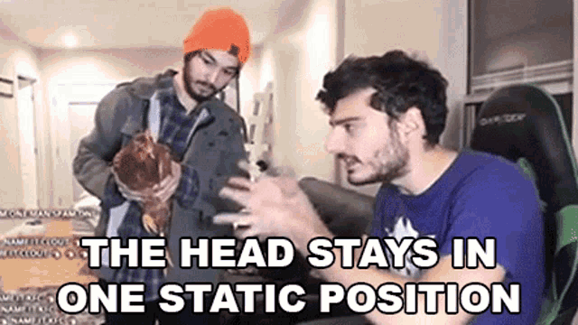 two men are standing next to each other in a living room holding a rooster .
