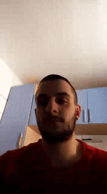 a man with a beard wearing a red shirt