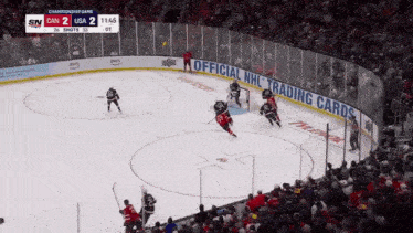 a hockey game is being played in front of a crowd with a banner for official nhl trading cards