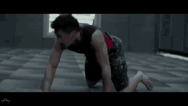a man is crawling on the floor in a dark room with the word xfinity on the bottom left
