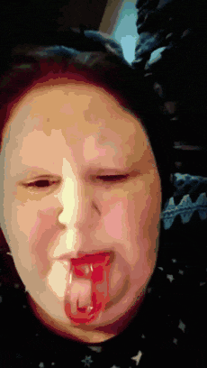 a close up of a person 's face with their tongue out