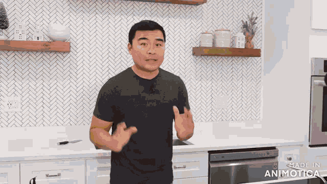a man in a black shirt is standing in a kitchen with the words made in animatica on the bottom