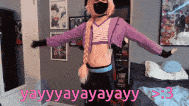 a person wearing a mask and a braided ponytail is standing in front of a bed and says yay
